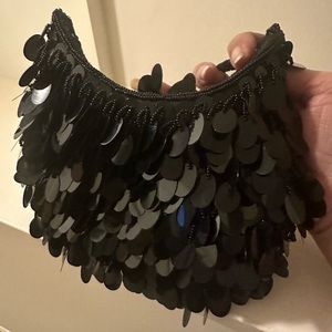 Fun cool round black dangling sequence. Great with jeans or dress